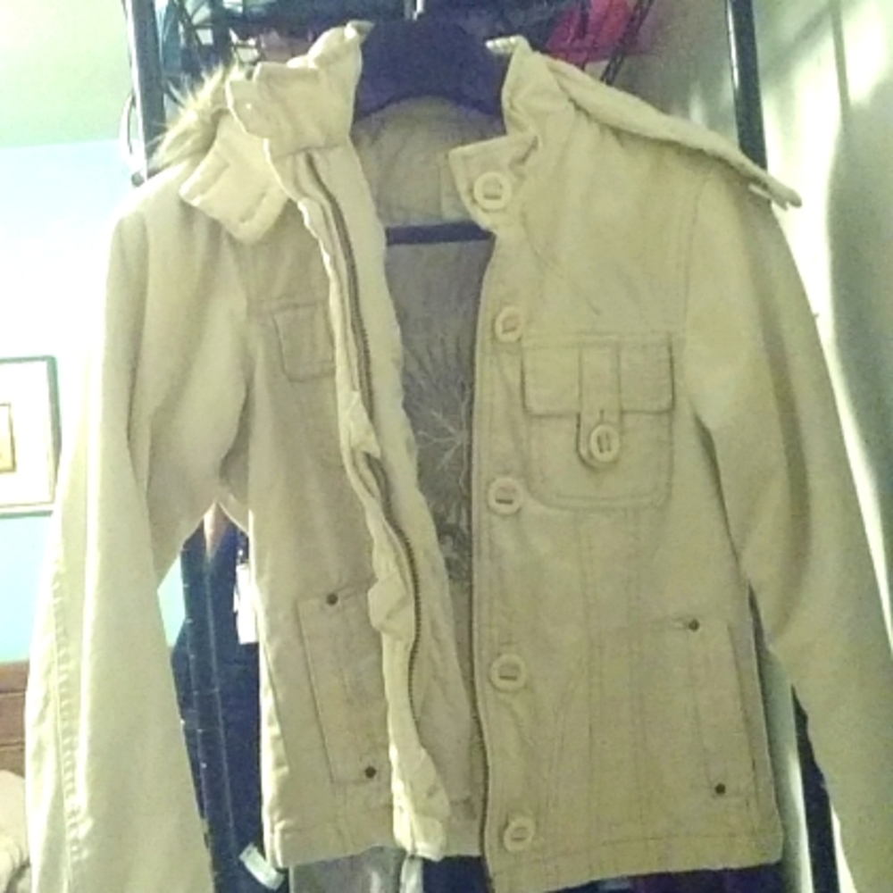 A soft half length trenchcoat.  It's color is a vibrant creamy cream color.